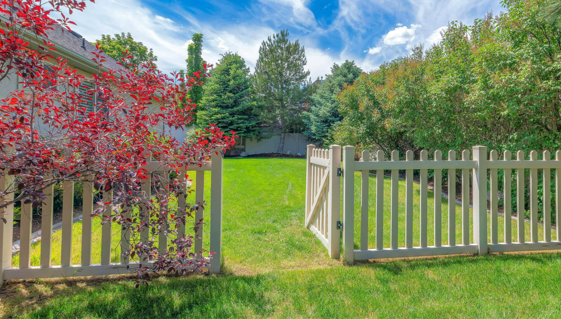 A functional fence gate providing access to a well-maintained backyard, surrounded by a wooden fence in Portland